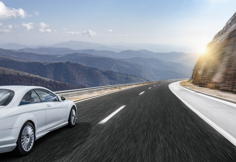 Driving in the mountains at sunset with a good mood